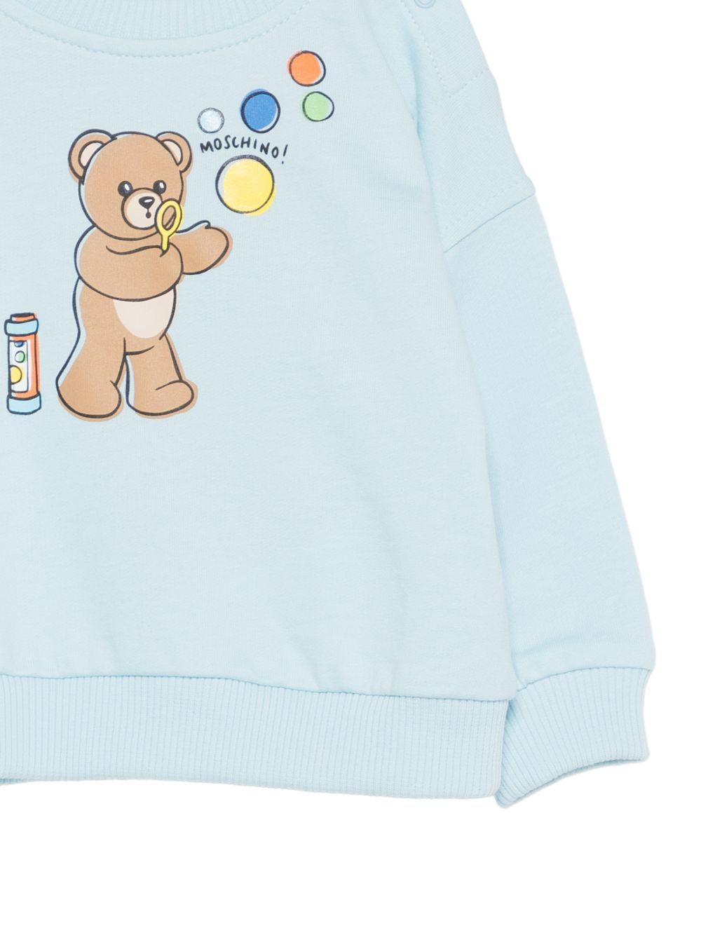 Felpa per neonati Moschino Kids azzurra con stampa grafica Teddy Bear MUF069LCA19 40304 MOSCHINO KIDS