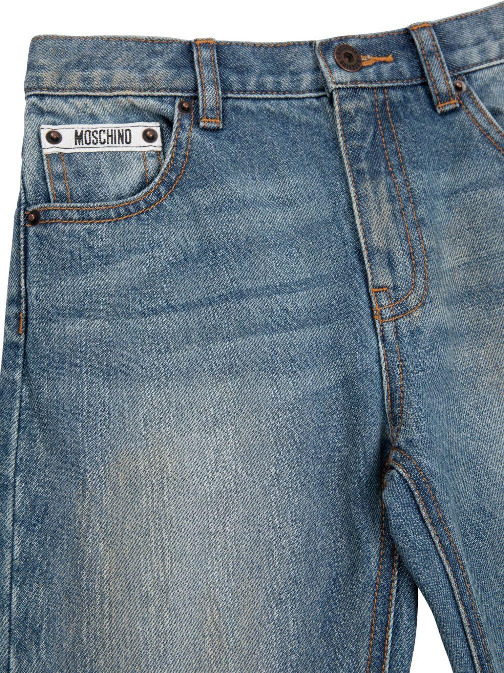 Jeans dritti per bambina Moschino Kids denim con design patchwork - Rubino Kids