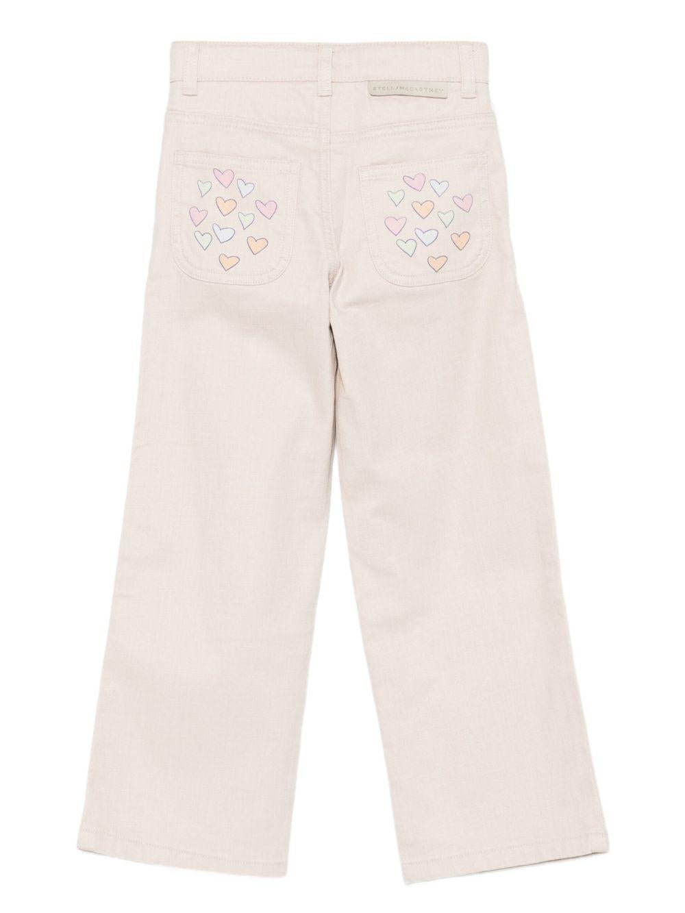 Pantaloni per bambina Stella McCartney Kids beige con stampa con cuori - Rubino Kids