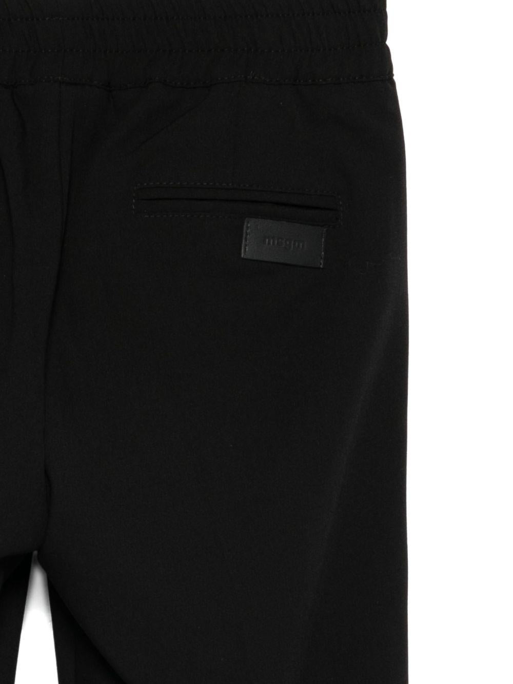 Pantaloni per bambini MSGM Kids neri con elastico in vita e orli svasati - Rubino Kids