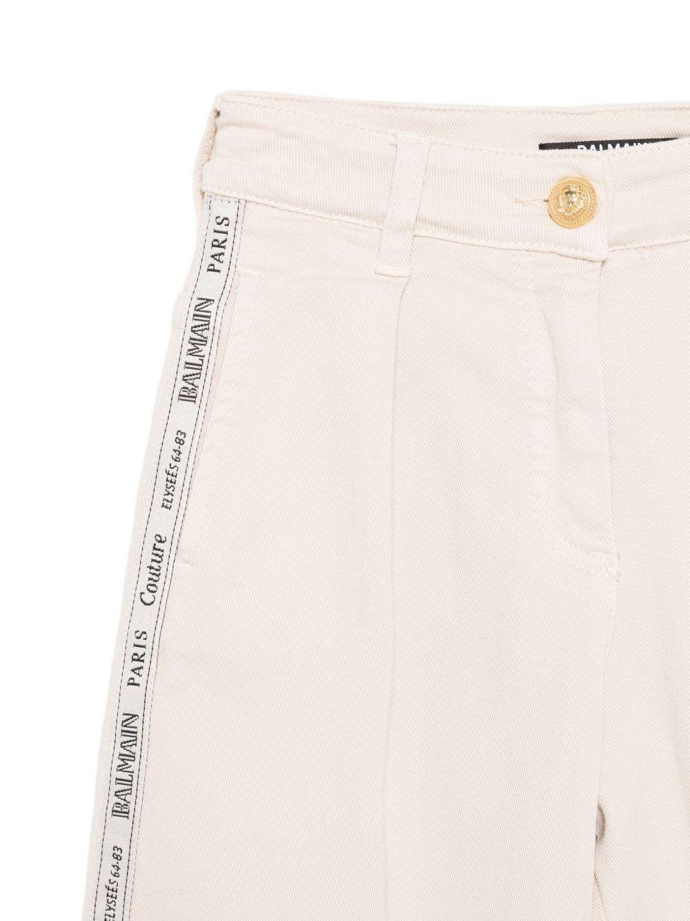 Pantaloni per bambino Balmain Kids beige con motivo logo - Rubino Kids