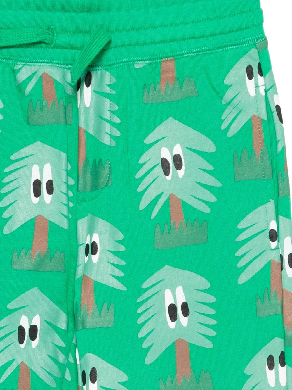 Pantaloni per bambino Stella McCartney Kids verde con stampa di alberi - Rubino Kids