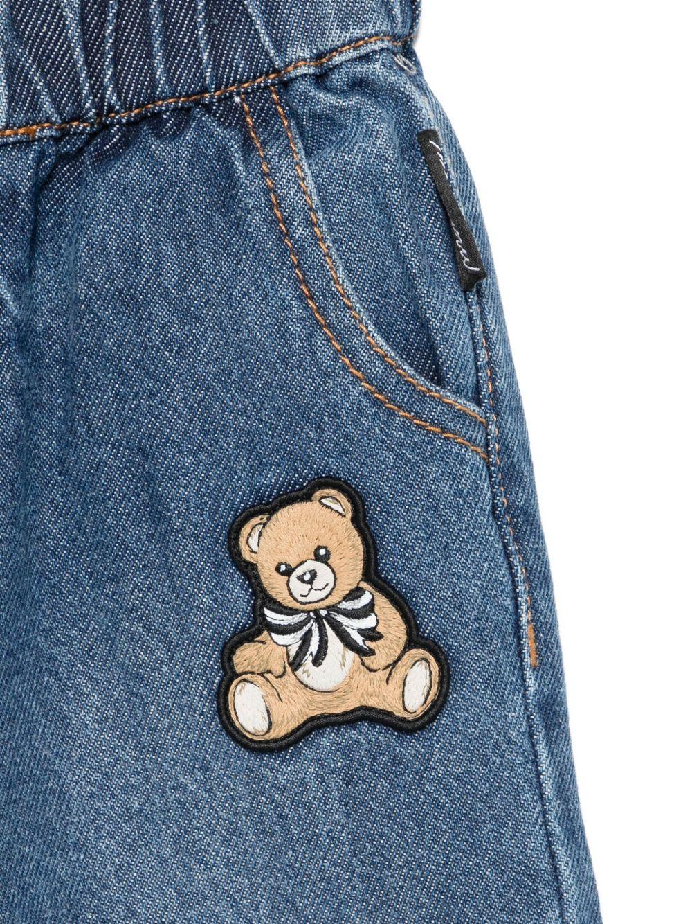Pantaloni per neonati Moschino Kids denim con toppa Teddy - Rubino Kids