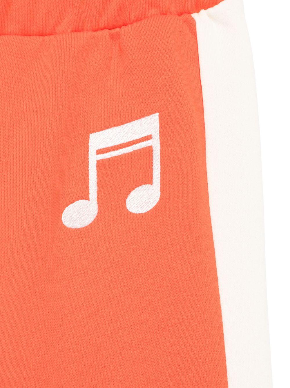 Pantaloni sportivi per bambina Mini Rodini Note rosso con dettaglio laterale a righe - Rubino Kids