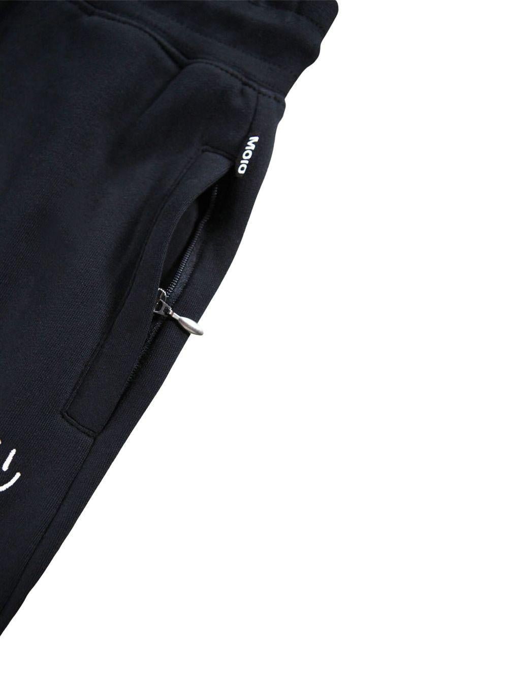 Pantaloni sportivi per bambino Molo Alvar nero con orli alle caviglie elasticizzati - Rubino Kids