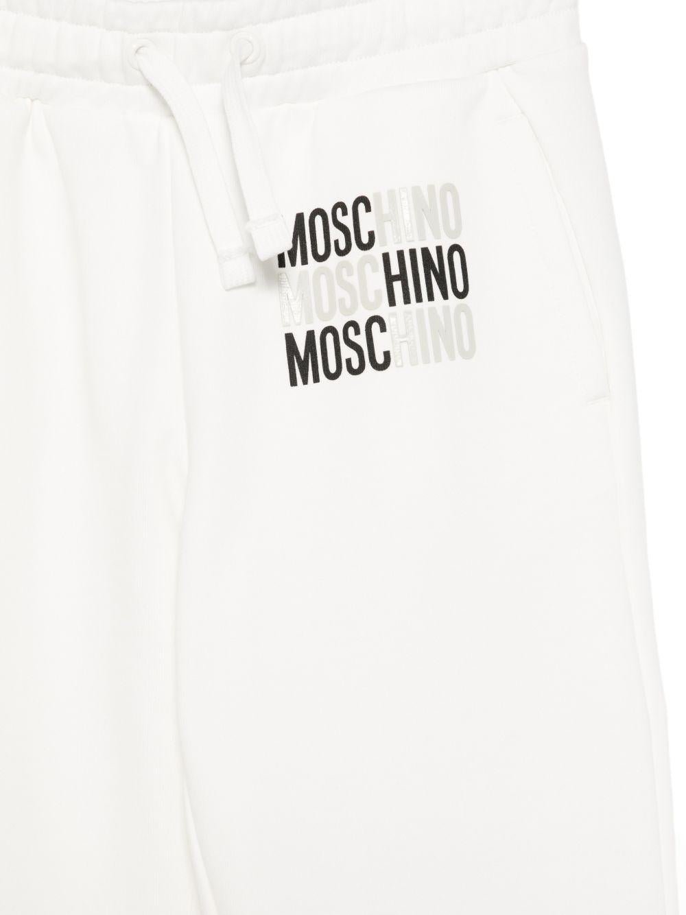 Pantaloni sportivi per bambino Moschino Kids bianchi con logo sul davanti - Rubino Kids
