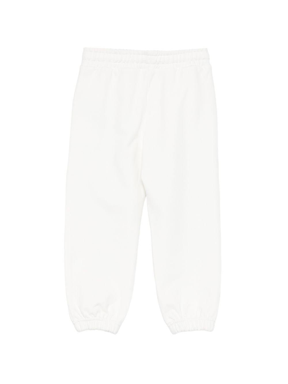 Pantaloni sportivi per bambino Moschino Kids bianchi con logo sul davanti - Rubino Kids