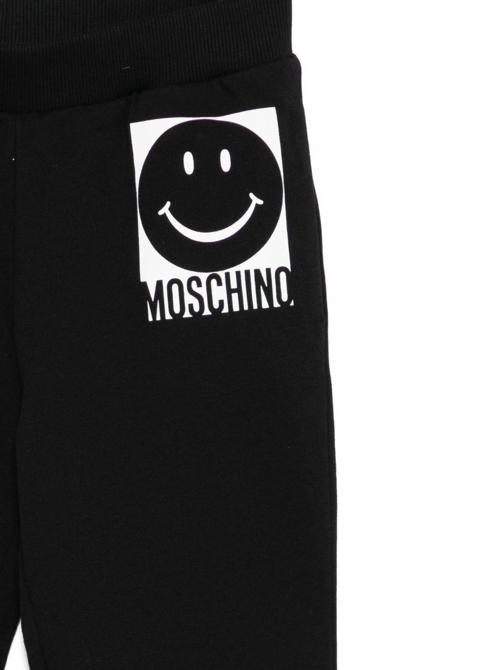 Pantaloni sportivi per bambino Moschino Kids nero con motivo a faccina sorridente - Rubino Kids