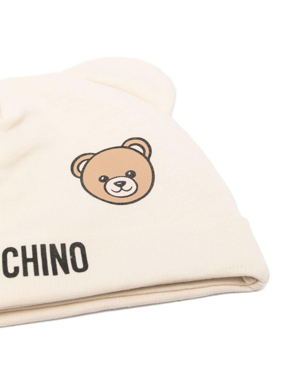 Set berretto e bavaglino per neonati Moschino Kids beige con stampa Teddy Bear - Rubino Kids