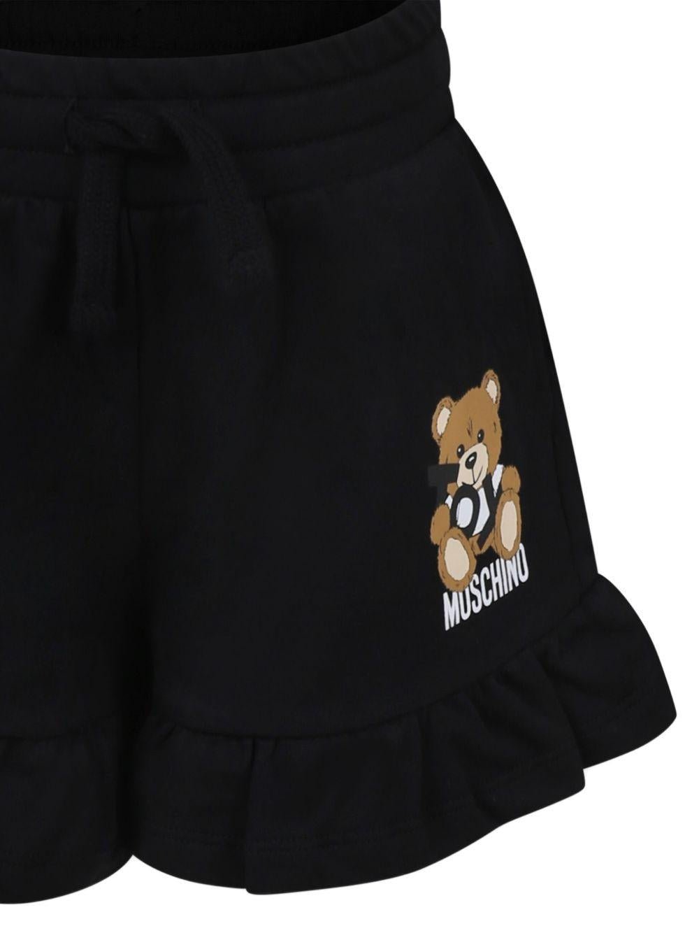 Shorts con motivo Teddy Bear per bambina Moschino Kids nero con logo sulla gamba - Rubino Kids