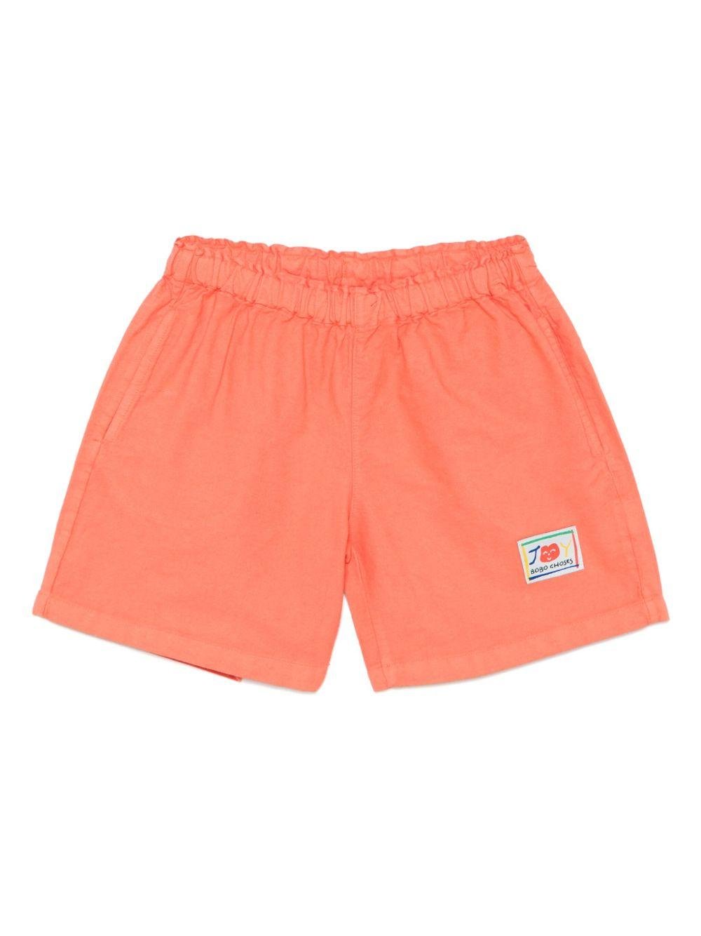Shorts per bambino Bobo Choses Similing arancione con logo applicato - Rubino Kids