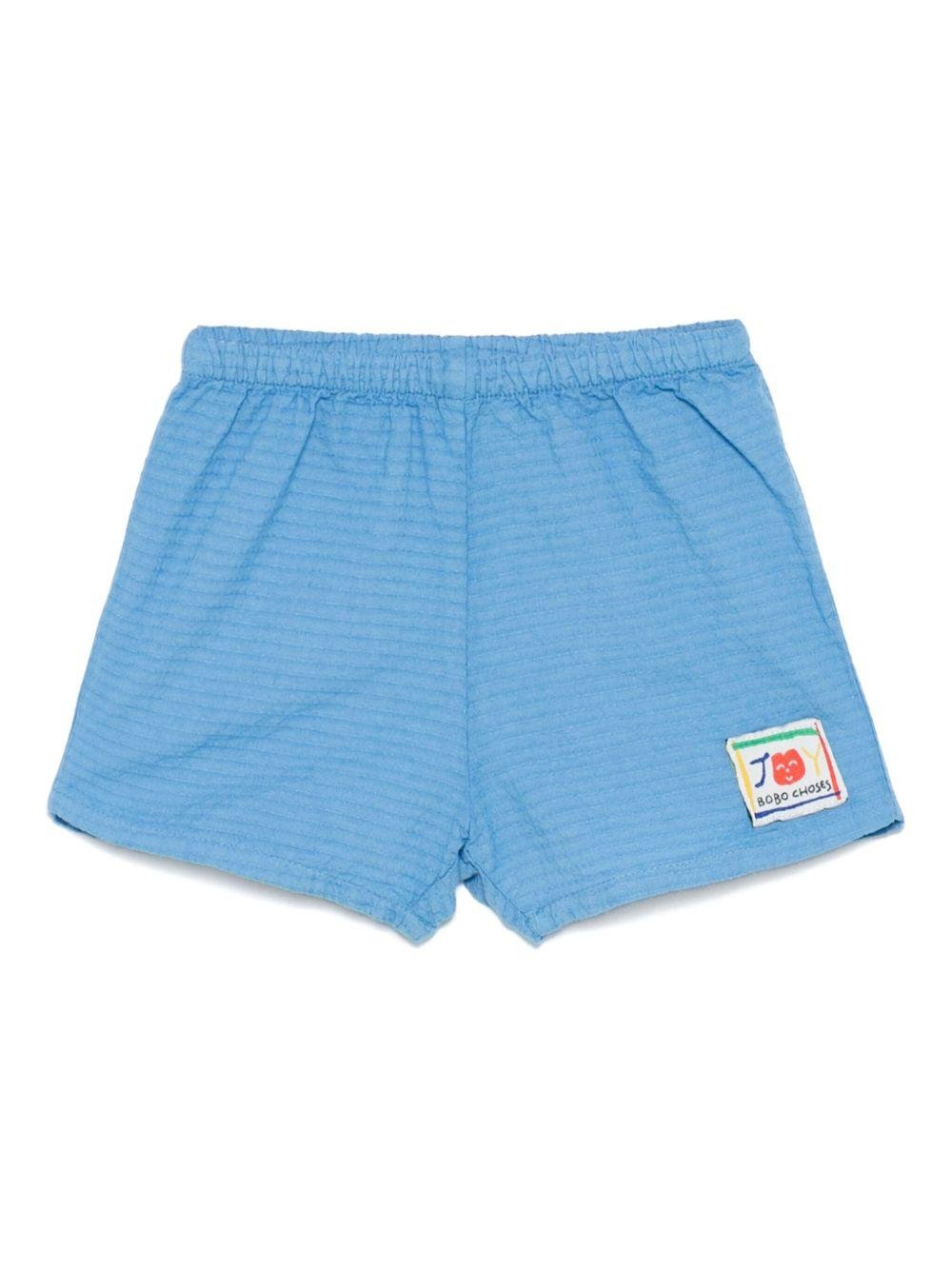 Shorts per neonato Bobo Choses Smilling azzurro con applicazione frontale con logo - Rubino Kids