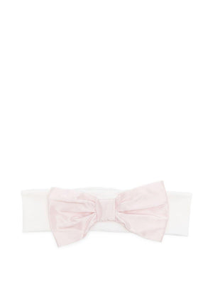 La Stupenderia baby headband in pink with a white bow