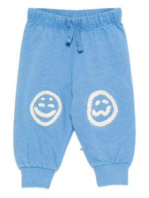 Simeon Molo baby boy's light blue sports trousers with smiley patches on the knees