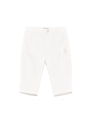 Pantaloni a righe per neonata Moschino Kids beige con passanti