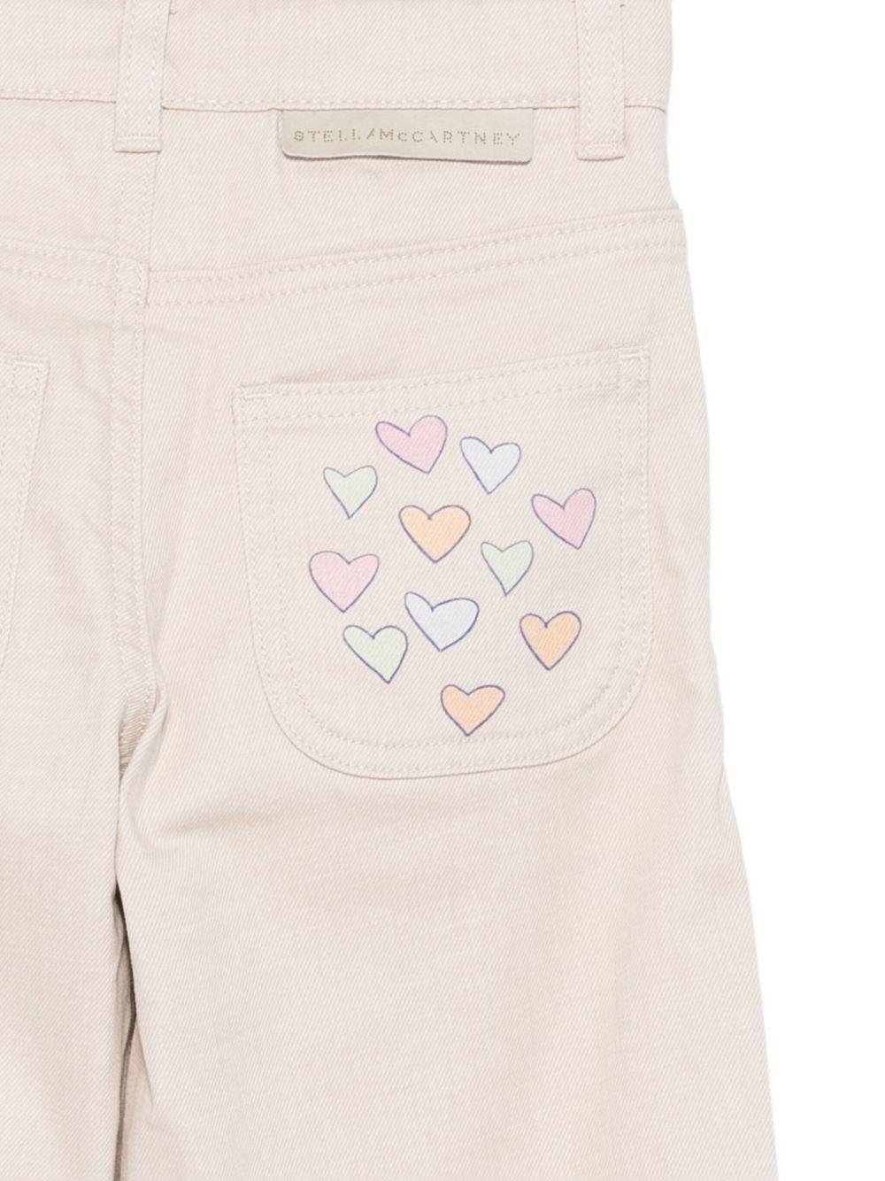 Pantaloni per bambina Stella McCartney Kids beige con stampa con cuori - Rubino Kids