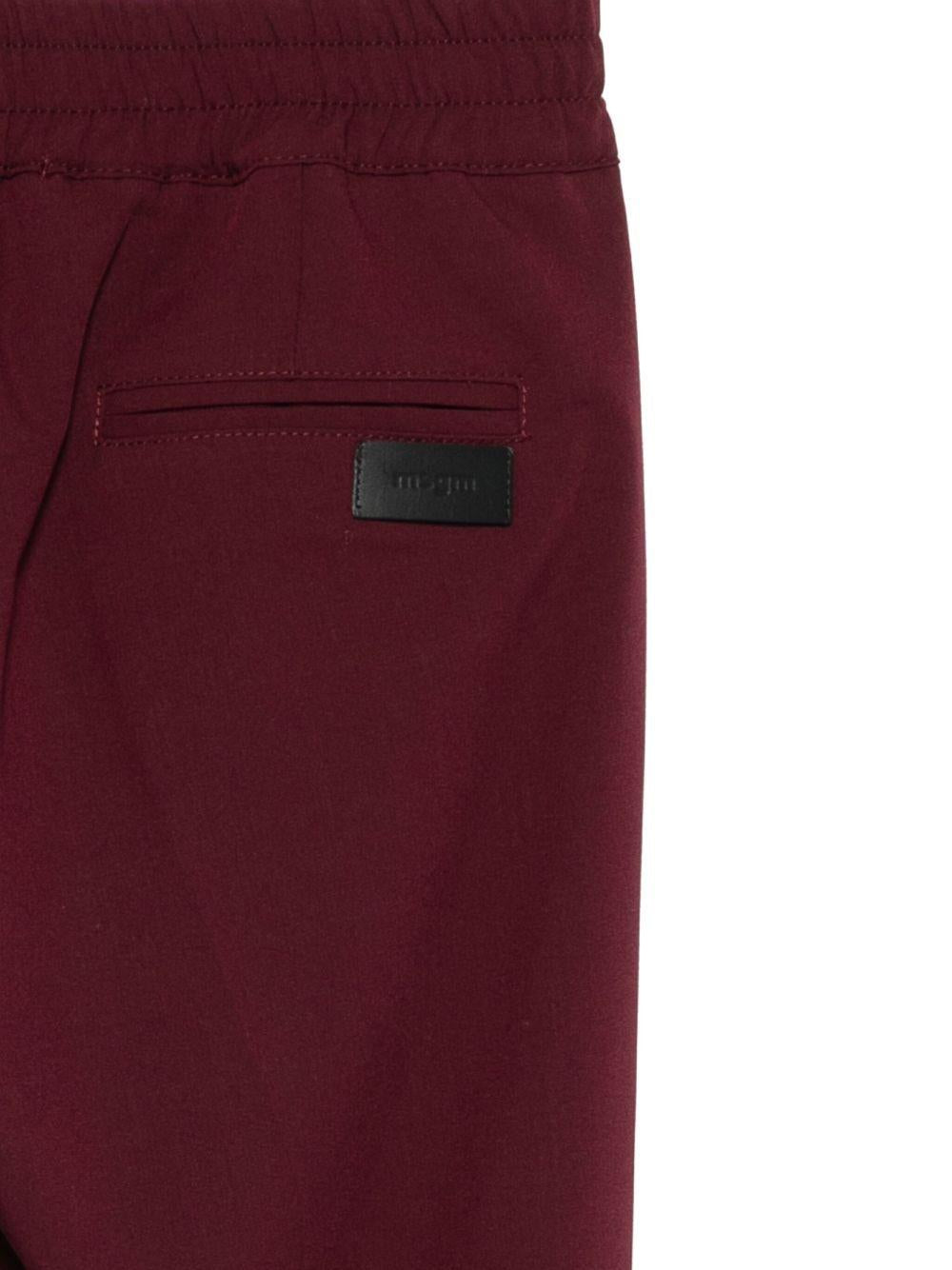 Pantaloni per bambini MSGM Kids bordeaux con elastico in vita e orli svasati - Rubino Kids