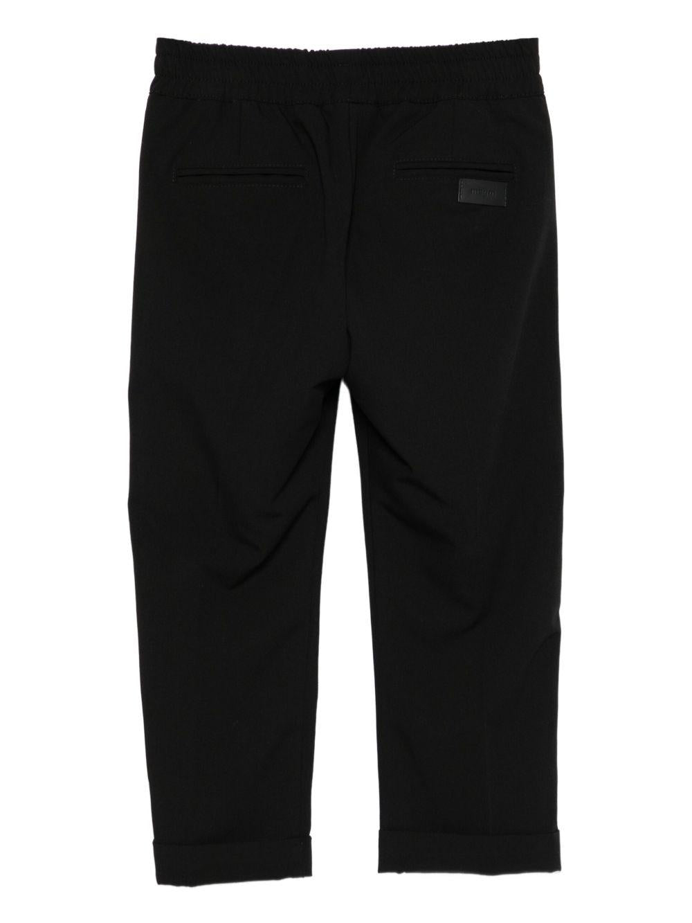 Pantaloni per bambini MSGM Kids neri con elastico in vita e orli svasati - Rubino Kids