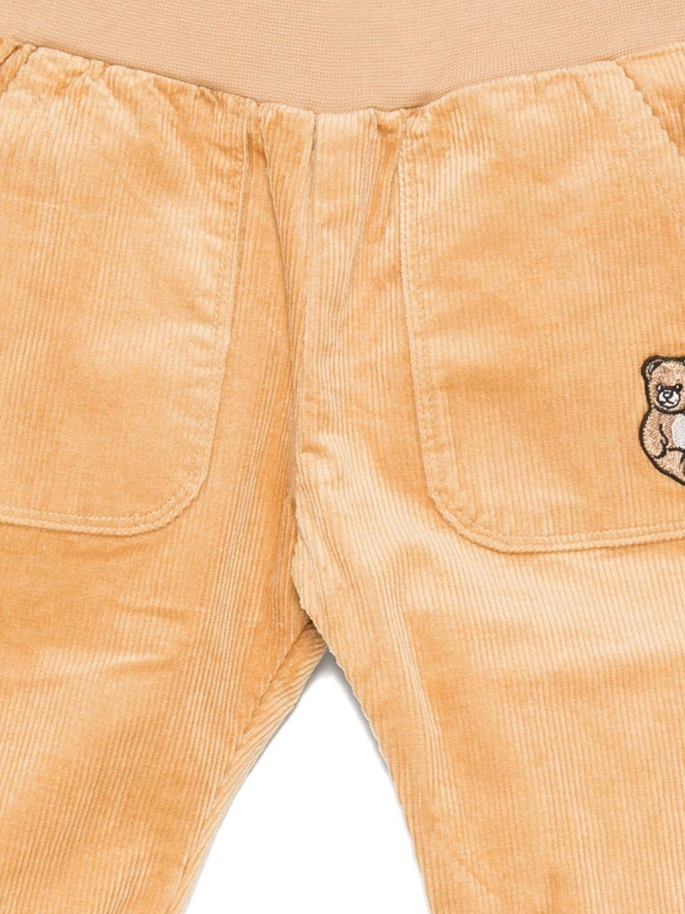 Pantaloni per neonato Moschino Kids beige di velluto a coste con ricami a forma di orsacchiotto - Rubino Kids