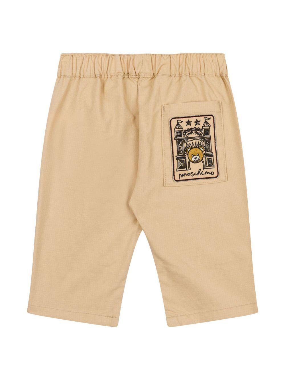 Pantaloni per neonato Moschino Kids marrone con applicazione logo - Rubino Kids
