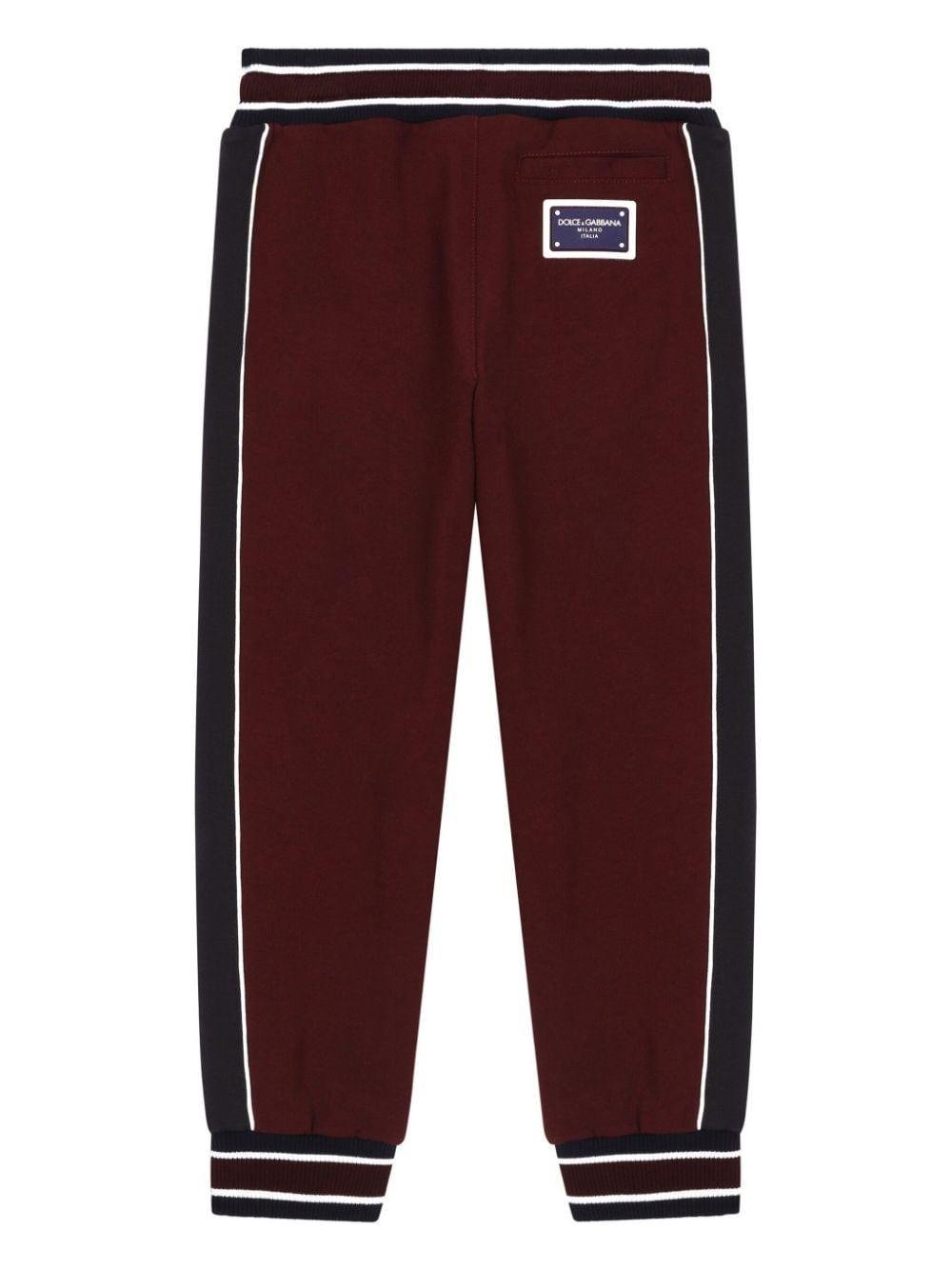 Pantaloni sportivi con logo per bambino Dolce & Gabbana Kids rosso con dettaglio a righe - Rubino Kids