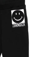 Pantaloni sportivi per bambino Moschino Kids nero con motivo a faccina sorridente - Rubino Kids
