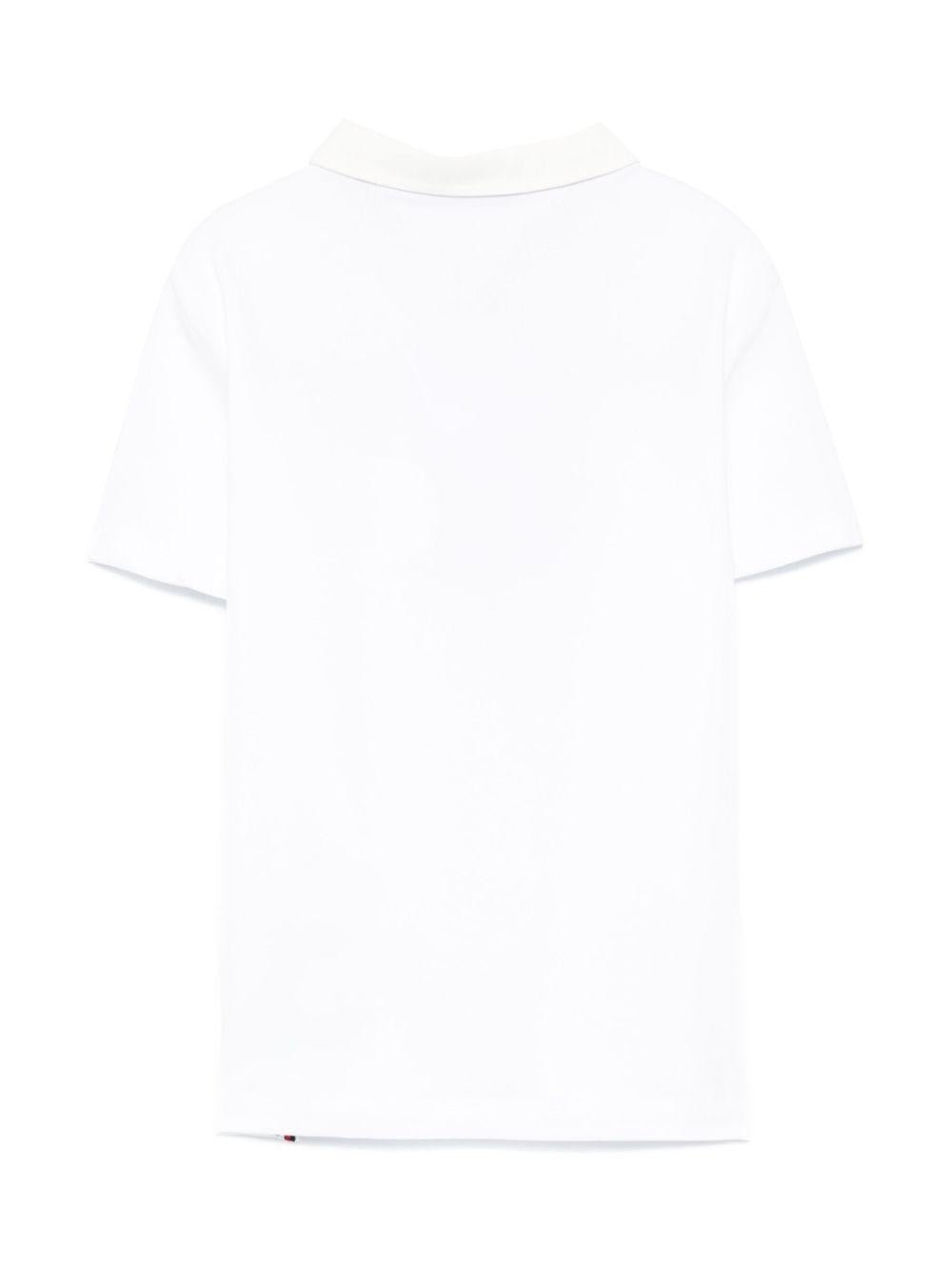 Polo con ricamo per bambino Tommy Hilfiger Junior bianco con spacchi laterali - Rubino Kids