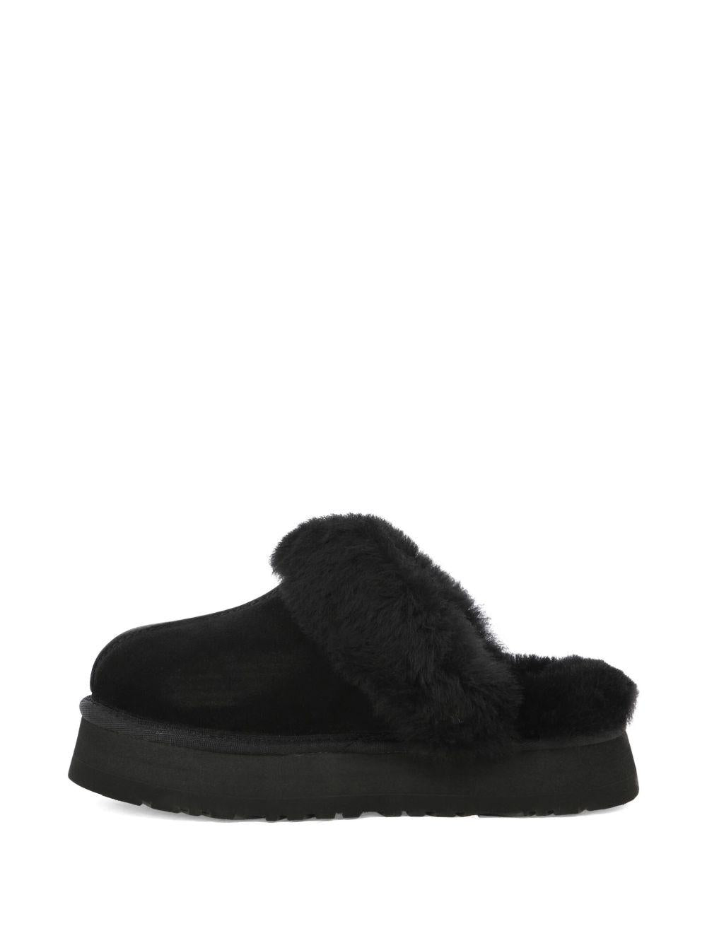 Slippers per bambina UGG Kids Disquette nero con finitura in pelliccia sintetica - Rubino Kids